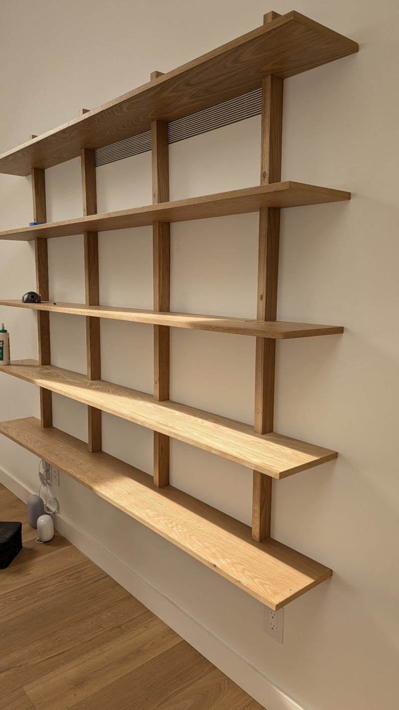 Wall-mounted wooden shelving with five shelves