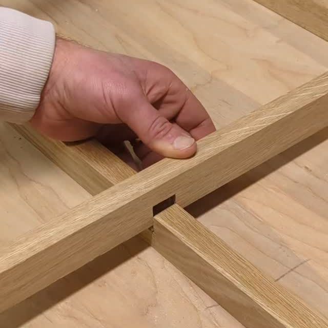Checking the joint on a white oak door frame at the bench