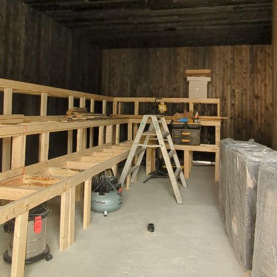 Cedar sauna benches taking shape inside a timber-lined room