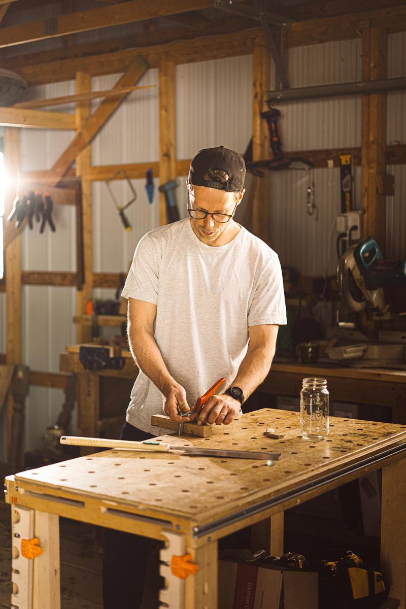 Adam Masson working at the bench in his shop